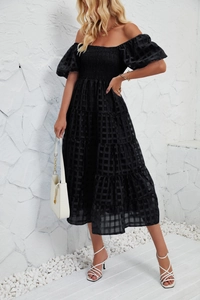 Detail of black off-shoulder tiered A-line dress with puff sleeves and textured grid fabric