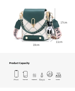 Detail view of green and white plaid bucket bag with gold lock and bear charm