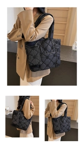 Detail of black quilted tote bag with floral embroidery and matching small zipper pouch