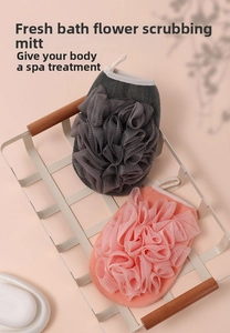 Close-up of dual-sided bath scrub gloves with mesh loofah sponge and hanging rope