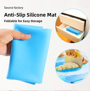 Blue food-grade silicone pastry mat showing foldable storage and non-slip kneading use