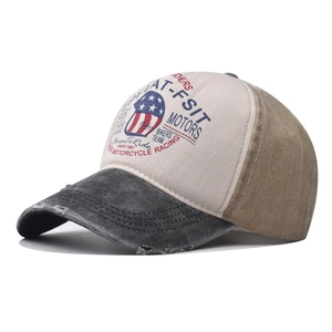 Detail of vintage washed baseball cap featuring distressed brim and motor theme print