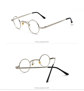 Detail view of silver metal round frame sunglasses with clear lenses and black ear tips