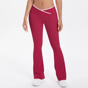 Detail of high waisted yoga pants with white cross waist design and flared hem