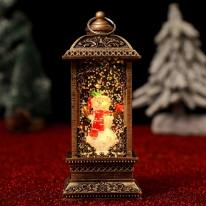 Close-up of bronze Christmas lantern featuring a snowman and glittering snow swirls
