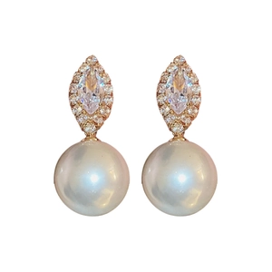Elegant gold earrings with marquise zircon stud and white drop pearl on white background