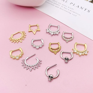 Assorted stainless steel septum rings in gold and silver finish with crystal details