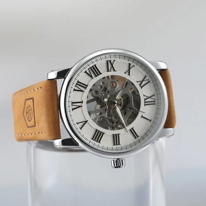 Macro shot of skeletal dial mechanism with Roman numerals and brown leather strap