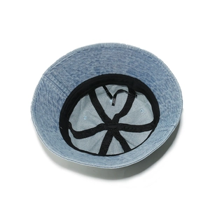 Close-up of washed denim bucket hat interior with sweatband and adjustable drawstring
