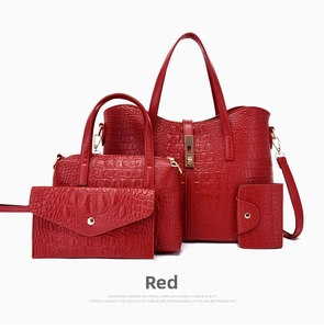 Detail view of 4-piece set red crocodile embossed tote bags with gold metal hardware