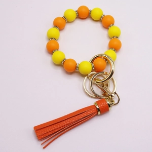 Schlüsselanhänger Armband mit Silikonperlen in Orange und Gelb und Quastenanhänger