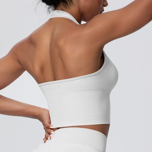 Back view of a white seamless halter yoga bra with wide ribbed band and cross back