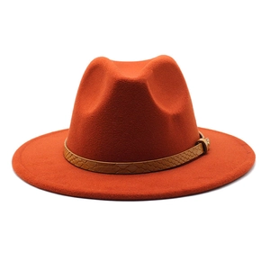 Detail of orange wool fedora with snakeskin leather band and gold buckle accent