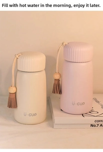 Detail of mini thermal flasks with non-slip lids and wooden bead tassel decorations