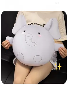 Large soft plush elephant pillow held by person showing the giant round shape and size