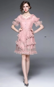 Detailed view of pink floral lace dress with V-neckline and layered ruffle trim accents