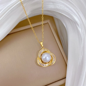 Detailed macro view of a gold pearl necklace with diamond accents on white silk