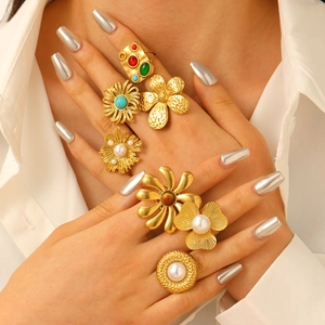 Bohemian gold ring set featuring turquoise and pearls in an oversized floral aesthetic