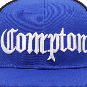 Detailed view of white Compton 3D embroidery on deep blue cotton street style mesh cap