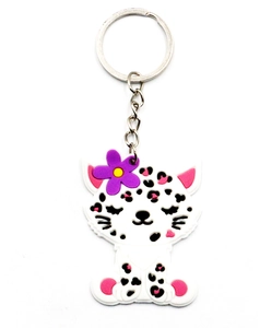 Close-up of cute white cat keychain with purple flower and pink paw details