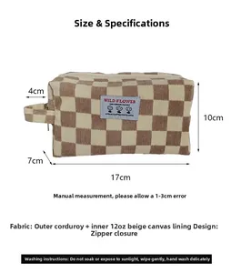 Macro view of corduroy checkered makeup bag showing zipper detail and canvas lining