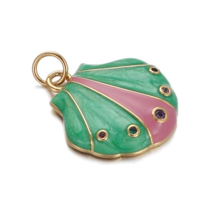 Close-up of a 14K gold plated shell charm with green and pink enamel and crystals