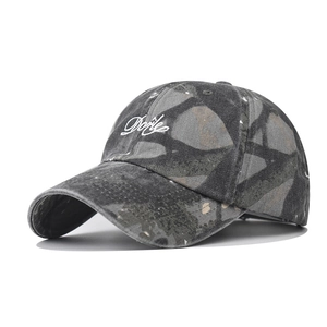 Detailed view of vintage washed camouflage baseball cap with white cursive Doyle embroidery