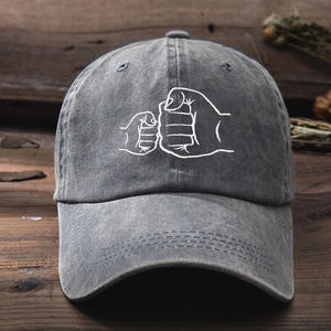 Vintage washed charcoal gray cotton baseball cap with embroidered fist bump parent-child design