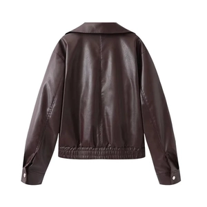 Detail view of the back of a vintage dark brown leather jacket with smooth texture