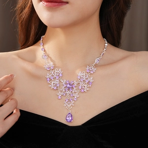 Detail of vintage flower necklace with purple zircon waterdrop pendant on model