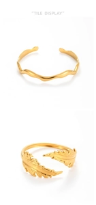 Detail of gold brushed stainless steel ginkgo leaf ring and wavy texture open bangle