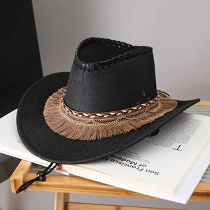 Detailed close-up of a black straw cowboy hat with golden chains and brown fringe decor