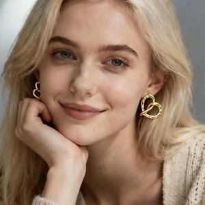 Chic 18k gold plated twisted heart stud earrings worn by a model for a stylish look