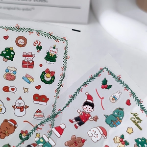 3D embossed Christmas nail stickers featuring Santa and Reindeer designs in a cute cartoon style