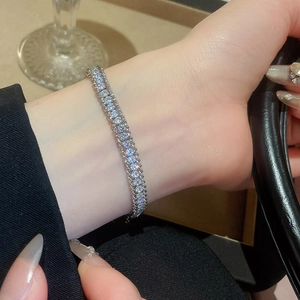 Close-up of double-row rhinestone chain bracelet in silver finish worn on the wrist