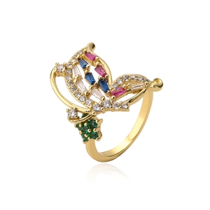Macro detail of a gold butterfly ring featuring multi-color cubic zirconia stones