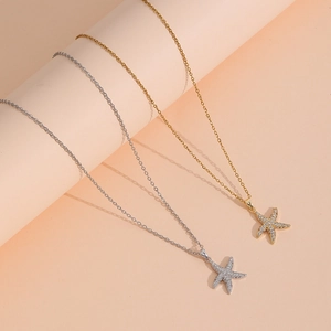 Elegant gold and silver starfish pendant necklaces with sparkling crystals on fine chains