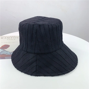 Détail du bob noir à rayures avec texture de tissu unique sur une surface blanche pure