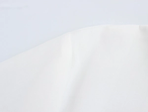 Detailed close-up of high-quality white woven fabric stitching on palm tree vacation set