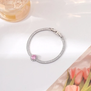 Detail of silver bracelet featuring a pink round stone and sparkling zircon pavé