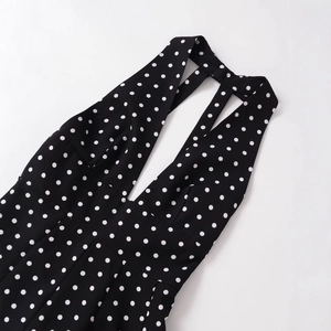 Polka dot V-neck halter dress with crisscross back detail on a clean white background
