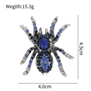 Broche araignée vintage avec strass bleus et pierre œil de chat sur alliage argenté