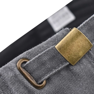 Detail of vintage brass buckle and adjustable strap on a washed gray baseball cap