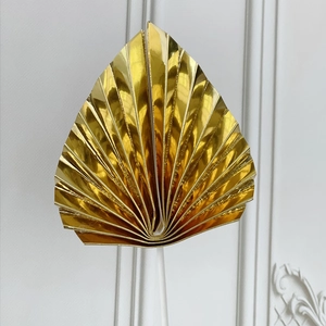 Golden fan-shaped palm leaf cake topper with metallic glossy finish for party decor
