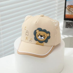 Detail of cute beige cotton baseball cap featuring a 3D lion patch and small decorative ears