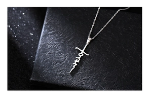 Detailed close-up of a silver Faith letter pendant necklace on a premium black jewelry box