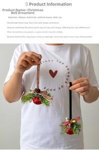Detail of Christmas metal bell pendant with pine needles, cones and red plaid ribbon