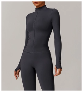 Detail of slim-fit seamless yoga jacket with high collar, zipper, and thumbhole cuffs