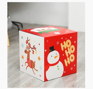 Close-up of festive Christmas gift box with Santa, reindeer and snowman illustrations