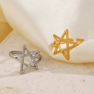 Adjustable gold and silver hollow star stainless steel rings on silk background
